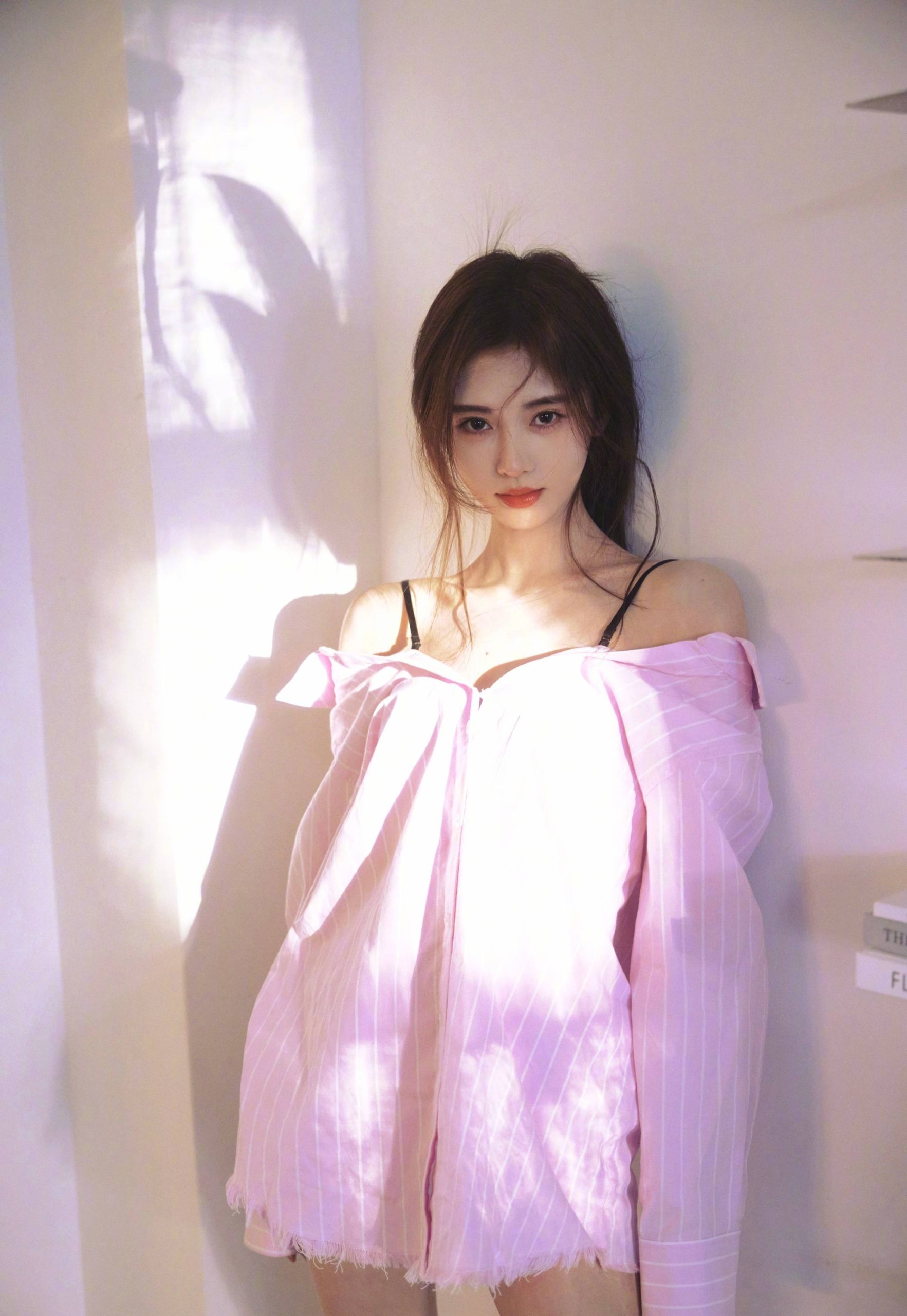鞠婧祎在个人社交平台晒出一组写真，穿着粉色吊带短裙大秀直角肩